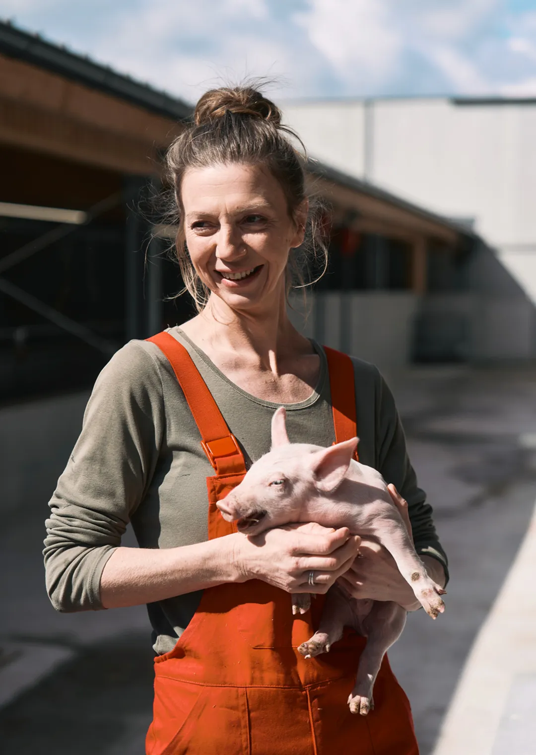 Barbara Holzinger hält ein Ferkel in der Hand